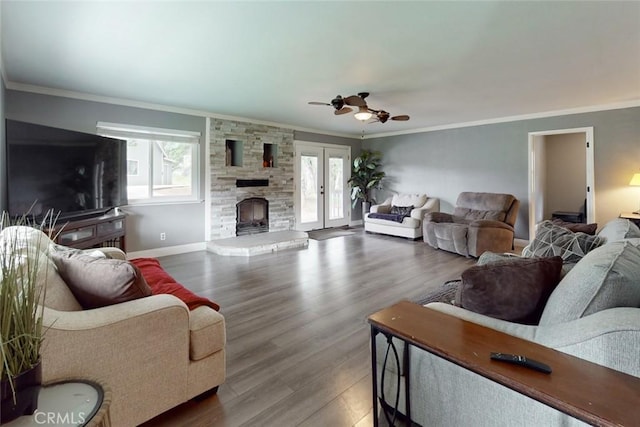 living area with crown molding, french doors, wood finished floors, and a healthy amount of sunlight