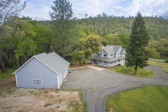 drone / aerial view with a wooded view