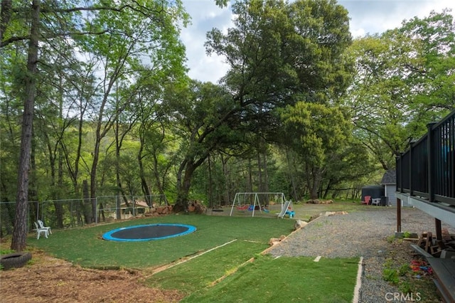 view of yard with fence and a playground