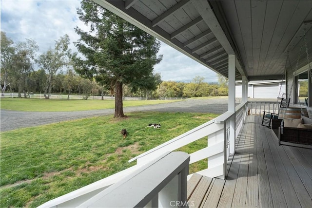 deck with covered porch and a lawn