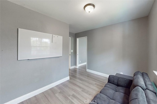 living room with light wood-style flooring and baseboards