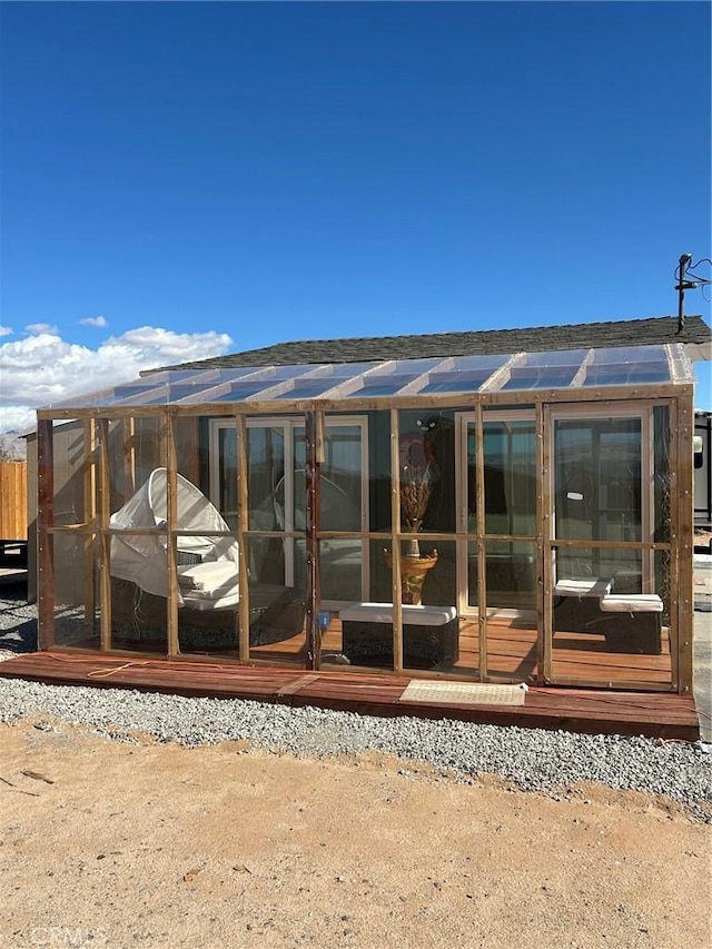 rear view of property with solar panels