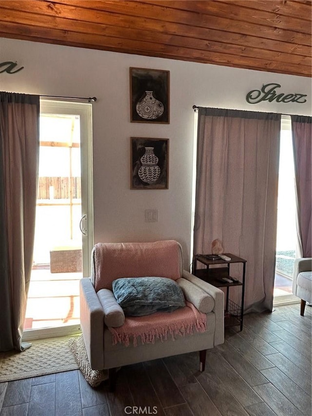 sitting room with wooden ceiling and wood finished floors