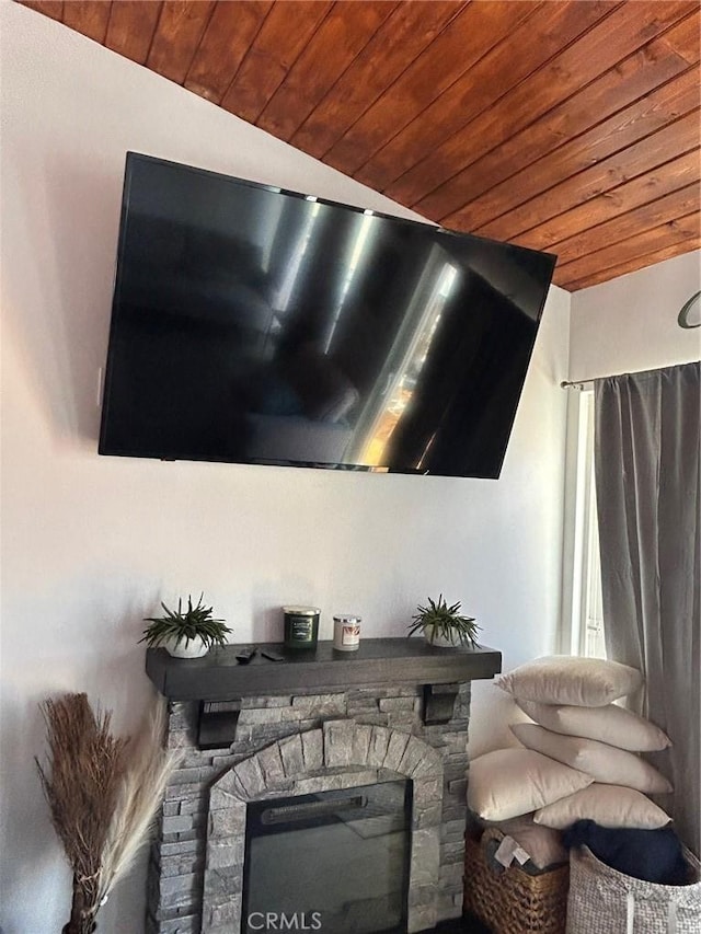 interior details featuring wooden ceiling and a stone fireplace