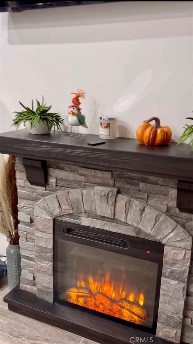 details with a fireplace and wood finished floors