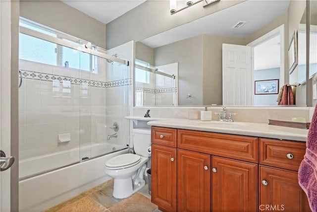 bathroom featuring vanity, toilet, visible vents, and combined bath / shower with glass door