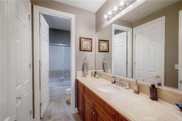 full bath featuring visible vents, bath / shower combo with glass door, toilet, and vanity