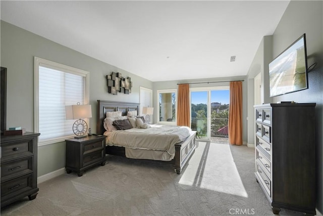 bedroom featuring access to outside, visible vents, baseboards, and light carpet