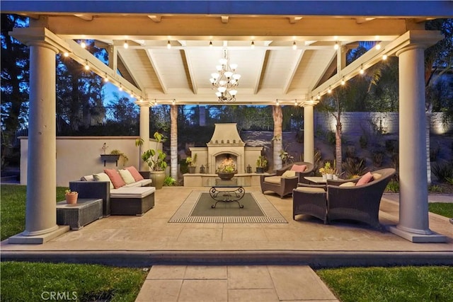 view of patio / terrace featuring an outdoor living space with a fireplace and fence private yard