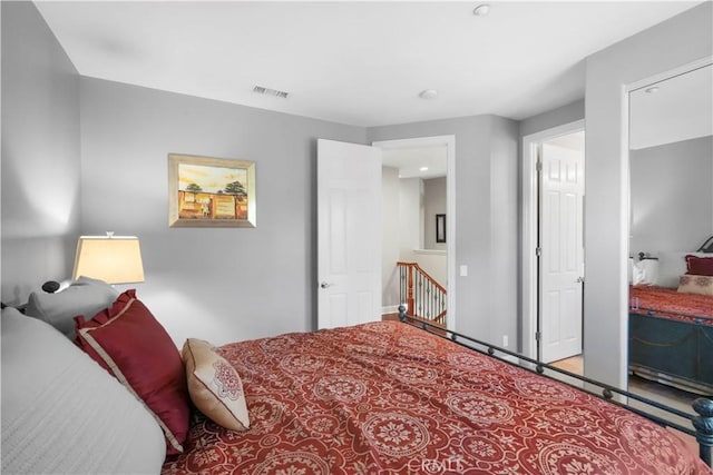 carpeted bedroom with visible vents