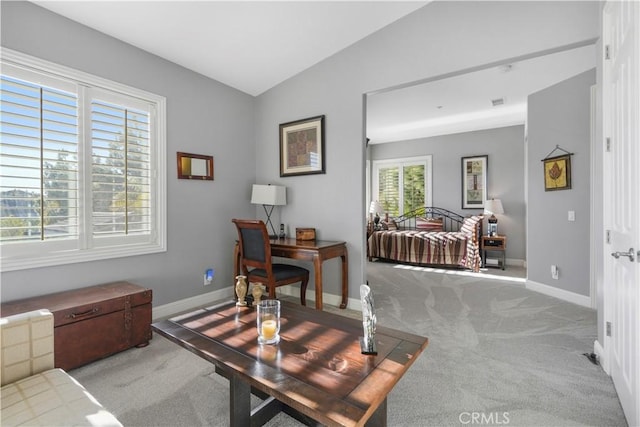 carpeted home office with baseboards and vaulted ceiling