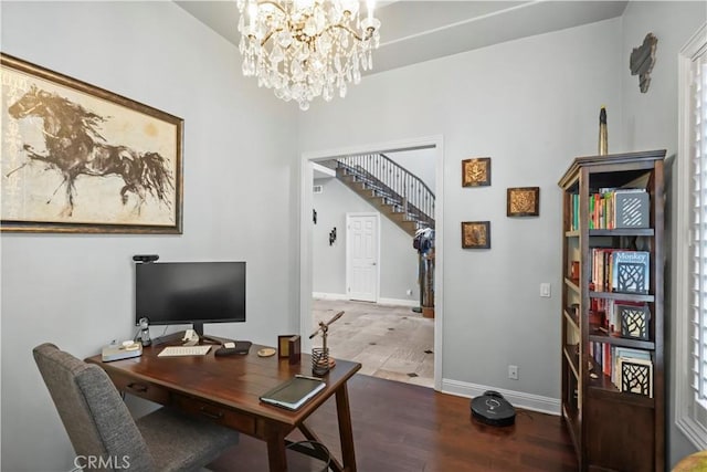 office featuring an inviting chandelier, baseboards, and wood finished floors