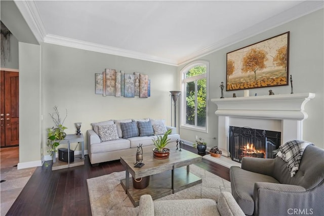 living room with baseboards, wood finished floors, a warm lit fireplace, and ornamental molding