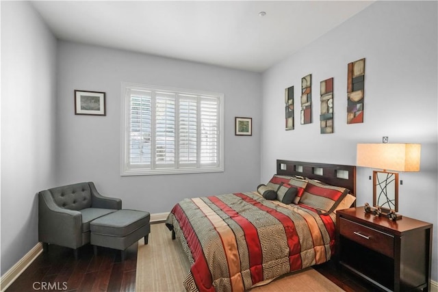 bedroom featuring wood finished floors and baseboards