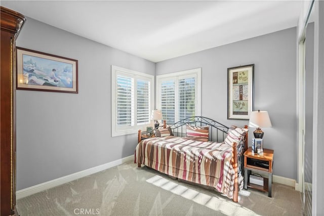 carpeted bedroom with baseboards