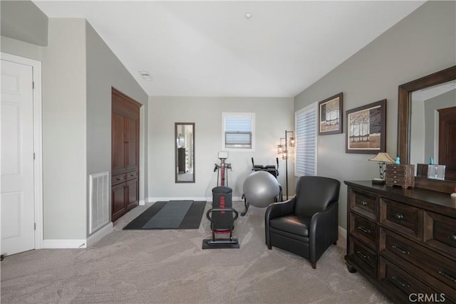 sitting room with visible vents, light carpet, and baseboards