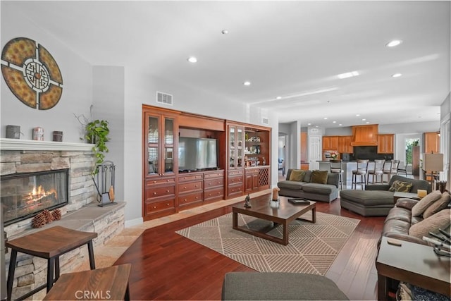 12364 Palmer Dr, Moorpark, CA 93021 - living area with visible vents, recessed lighting, wood finished floors, and a stone fireplace