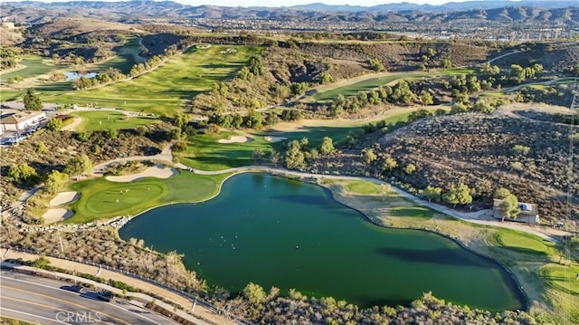 drone / aerial view with a water and mountain view and view of golf course