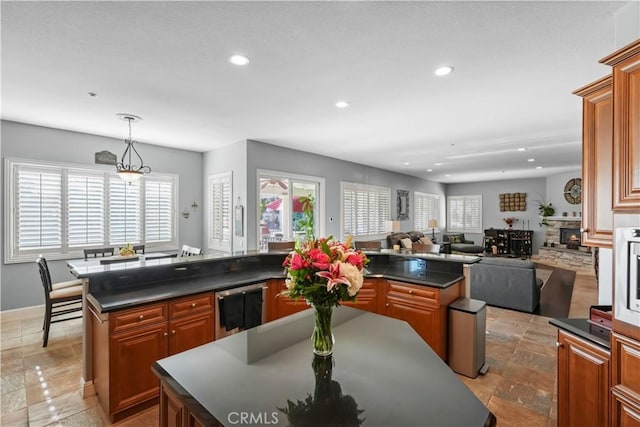 kitchen with dishwashing machine, recessed lighting, dark countertops, and a wealth of natural light