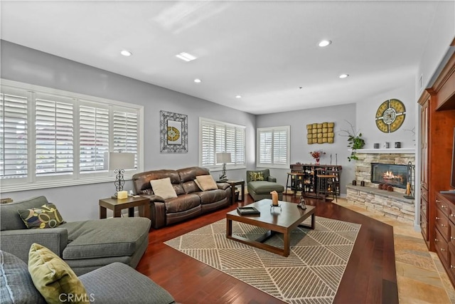 living room with a fireplace, wood finished floors, and recessed lighting