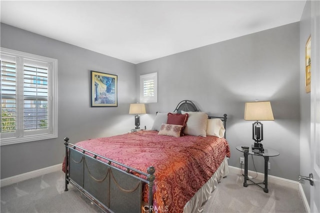 bedroom with baseboards and carpet floors