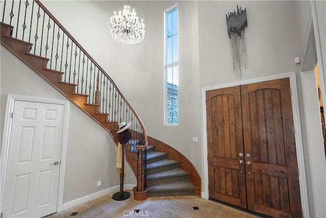 12364 Palmer Dr, Moorpark, CA 93021 - foyer featuring tile patterned floors, a chandelier, baseboards, a towering ceiling, and stairway