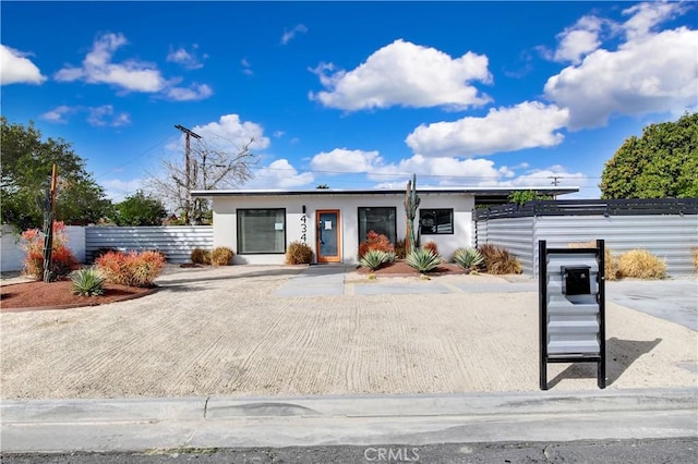 view of front of property featuring fence and stucco siding