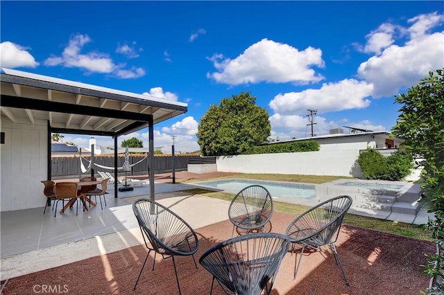 view of patio / terrace featuring a fenced backyard, outdoor dining area, and a fenced in pool