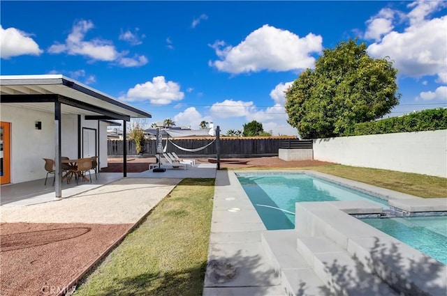 view of pool featuring a patio area, a fenced backyard, and a pool with connected hot tub