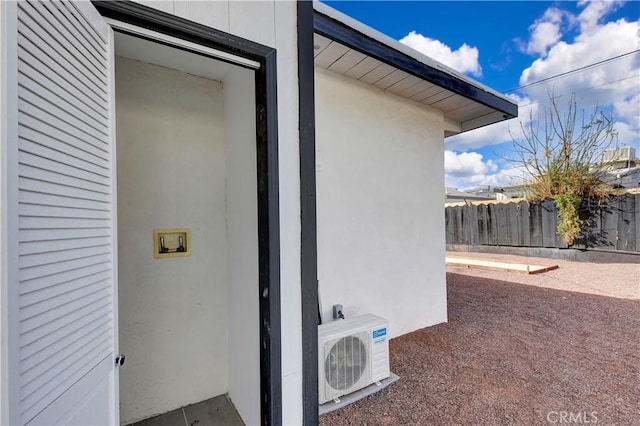 exterior space featuring ac unit and fence