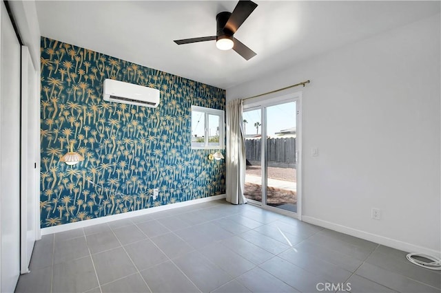 tiled spare room with a wall unit AC, wallpapered walls, and baseboards