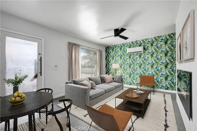 living area with a ceiling fan, baseboards, and wallpapered walls