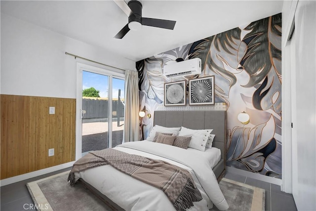 bedroom with a ceiling fan, a wainscoted wall, access to exterior, wood walls, and a wall mounted AC