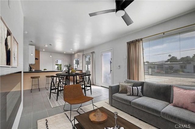 tiled living room featuring ceiling fan and recessed lighting