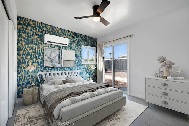 tiled bedroom with access to exterior, a wall mounted AC, an accent wall, baseboards, and wallpapered walls