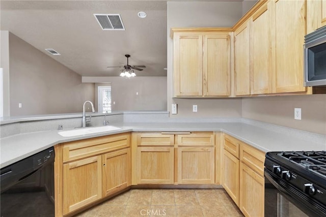 kitchen featuring visible vents, light countertops, light brown cabinetry, black appliances, and a sink