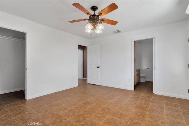 unfurnished bedroom featuring baseboards, visible vents, and a spacious closet
