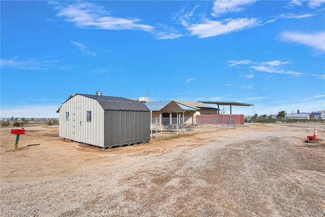 exterior space featuring an outdoor structure, a storage shed, and fence