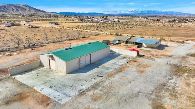 birds eye view of property featuring a mountain view, a desert view, and a rural view