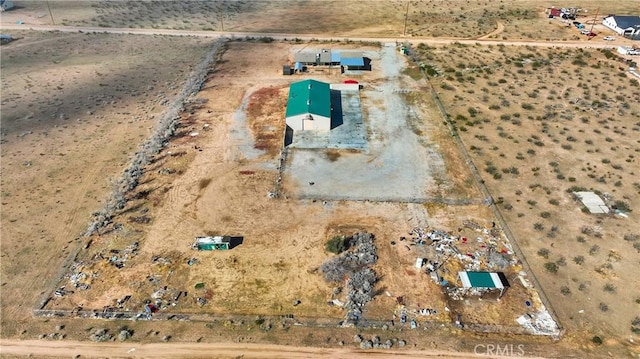 birds eye view of property featuring a rural view and a desert view