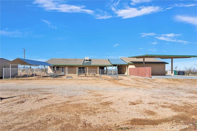 view of front of house with a detached carport and an outbuilding