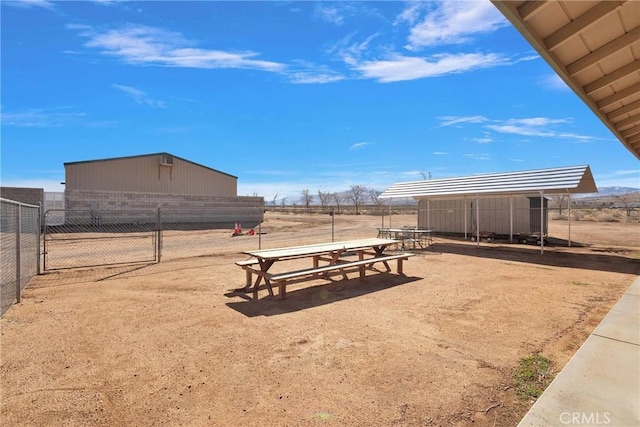 surrounding community with fence and an outdoor structure