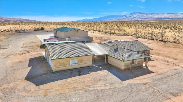 drone / aerial view featuring a mountain view, a desert view, and a rural view