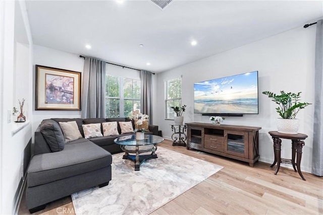 living room with baseboards, recessed lighting, and light wood-style floors