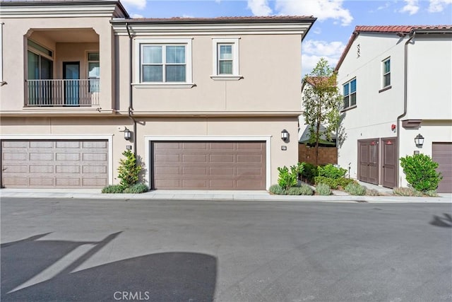 view of property featuring a garage and stucco siding