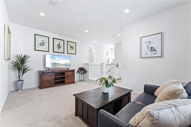 living room with recessed lighting, light colored carpet, and baseboards