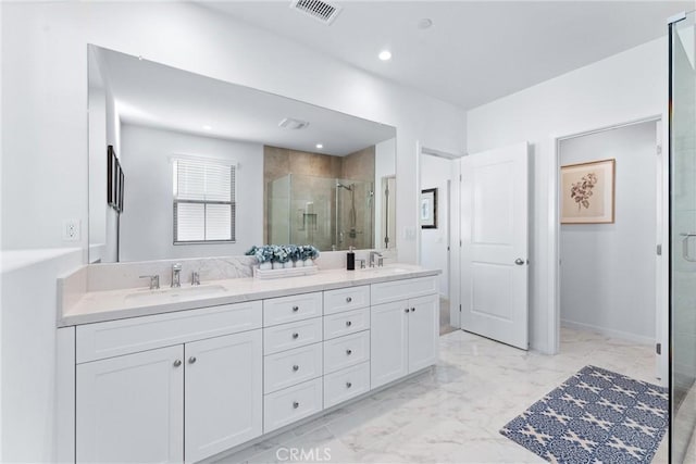 full bath featuring marble finish floor, double vanity, visible vents, a stall shower, and a sink