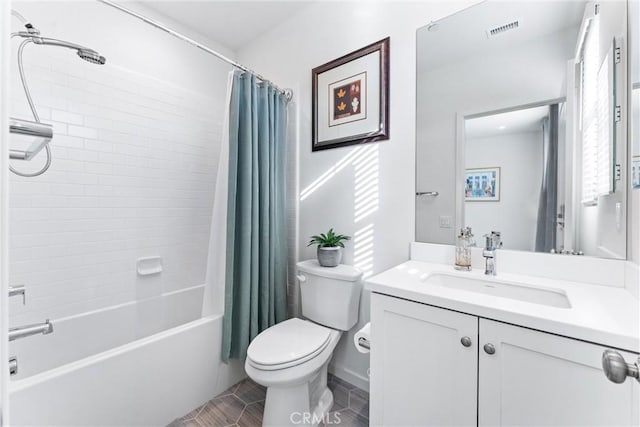 bathroom featuring toilet, vanity, visible vents, tile patterned floors, and shower / bath combo with shower curtain