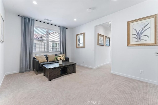 sitting room with light carpet, baseboards, and visible vents