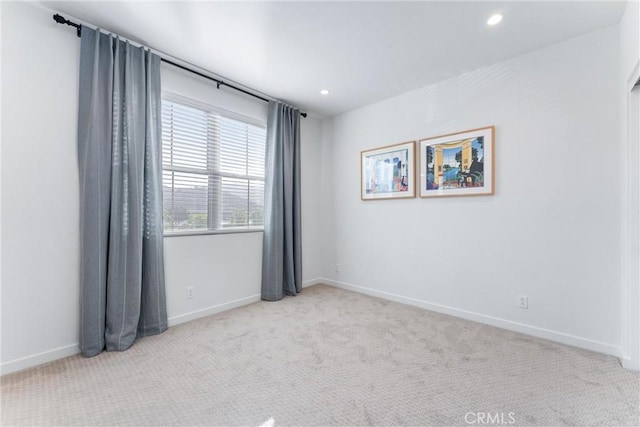 spare room featuring baseboards, carpet flooring, and recessed lighting